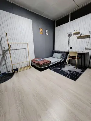 a room with a bed and a chair in it at 201-Olan Place Homely room Free Wi-Fi and Near BTS line in Bangkok