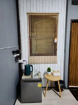 a small table and a window in a room at 201-Olan Place Homely room Free Wi-Fi and Near BTS line in Bangkok