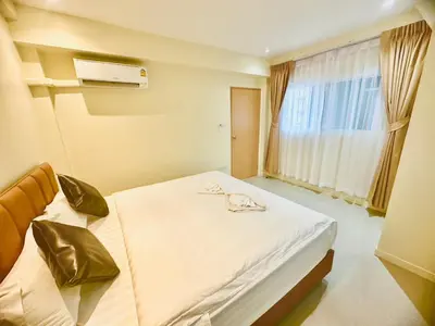 a bedroom with a bed and a window at ABC HA Hotel Bangkok in Bangkok