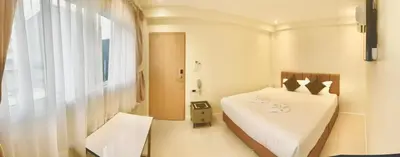 a bedroom with a white bed and a window at ABC HA Hotel Bangkok in Bangkok