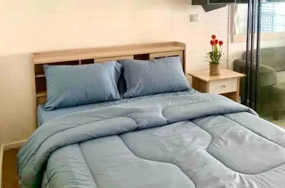 a large bed with blue pillows in a bedroom at Circle S Sukhumvit12 NearBTS,MRT in Bang Kapi