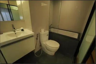 a bathroom with a white toilet and a sink at Circle S Sukhumvit12 NearBTS,MRT in Bang Kapi