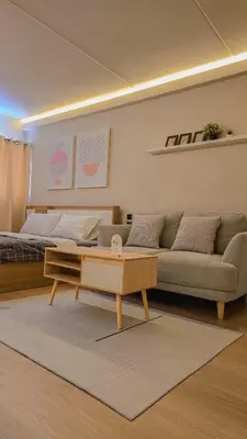 a living room with a couch and a coffee table at BetterRoom เมืองทองธานี C6 in Pak Kret