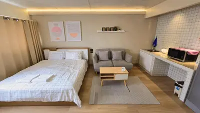 a small bedroom with a bed and a couch at BetterRoom เมืองทองธานี C6 in Pak Kret