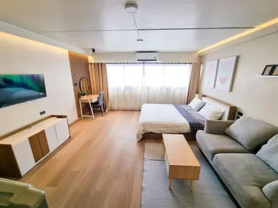 a living room with a couch and a bed at BetterRoom เมืองทองธานี C6 in Pak Kret