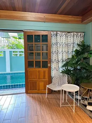 a room with a door and a chair and a table at T-house 10 -6BR Max15ppl whole house with pool in Bangkok