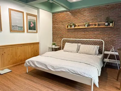 a bedroom with a bed and a brick wall at T-house 10 -6BR Max15ppl whole house with pool in Bangkok