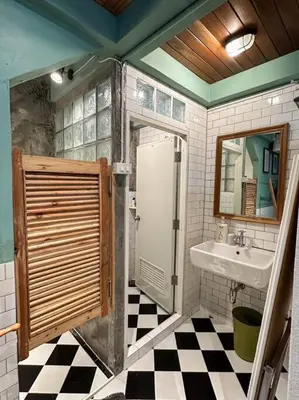 a bathroom with a sink and a mirror and a shower at T-house 10 -6BR Max15ppl whole house with pool in Bangkok