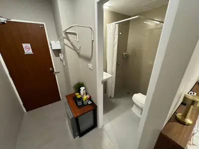 a small bathroom with a toilet and a shower at Rimm49 Bangkok in Bangkok