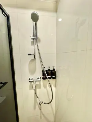 a shower with a shower head in a bathroom at Rimm49 Bangkok in Bangkok