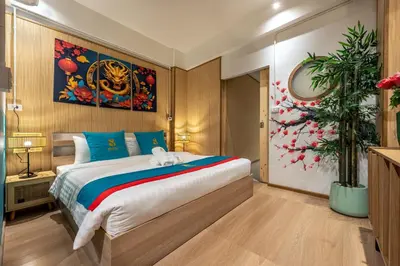 a bedroom with a large bed and a potted plant at SHIN Hotel Chinatown in Khlong San