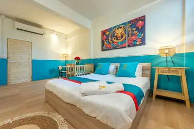 two beds in a room with blue and white at SHIN Hotel Chinatown in Khlong San