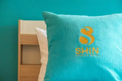 a pillow with the number six on it sitting on a bed at SHIN Hotel Chinatown in Khlong San