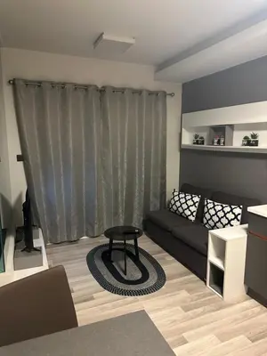 a living room with a couch and a table at Casa Bondia in Bangkok