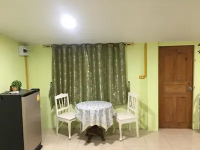 a dining room with a table and two chairs at GreenRoom Guest House Very Close Bangkok Hospital in Thailand in Bangkok
