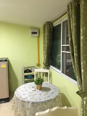 a table with a potted plant on it in a room at GreenRoom Guest House Very Close Bangkok Hospital in Thailand in Bangkok
