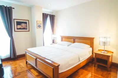 a bedroom with a large bed with white sheets at Chezmoi Bangkok Sukhumvit 26 Private Executive Residence 444 in Khlong Toei