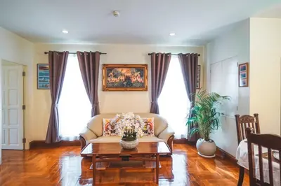a living room with a couch and a table at Chezmoi Bangkok Sukhumvit 26 Private Executive Residence 444 in Khlong Toei