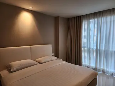 a bedroom with a bed and a large window at Condominium - Sukhumvit Soi 5 BTS Nana- Room Size 50m2 in Bangkok