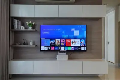 a flat screen tv sitting on a white entertainment center at Condominium - Sukhumvit Soi 5 BTS Nana- Room Size 50m2 in Bangkok
