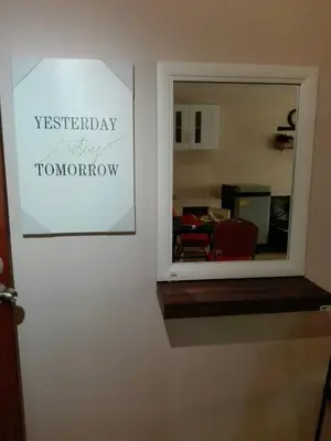 a mirror on a wall with a sign that reads yesterday happy tomorrow at SimpleRoomDesign, VeryClose Impact Muaungthongthani in Thung Si Kan