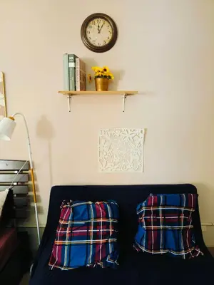 a bed with two pillows and a clock on the wall at SimpleRoomDesign, VeryClose Impact Muaungthongthani in Thung Si Kan