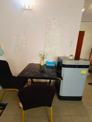 a small table and two chairs in a room at SimpleRoomDesign, VeryClose Impact Muaungthongthani in Thung Si Kan
