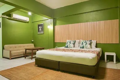 a bedroom with a large bed and a couch at XX GO INN The Grand Palace โกอินน์ พระบรมมหาราชวัง MRT สามยอด in Bangkok