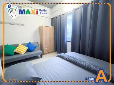 a room with a bed and a couch and curtains at MAXi MaMa Room in Bangkok