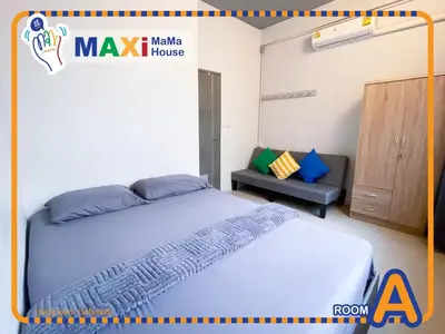 a bedroom with a large bed and a couch at MAXi MaMa Room in Bangkok