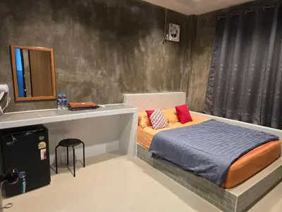 a small bedroom with a bed and a sink at Gail's Hostels in Bangkok