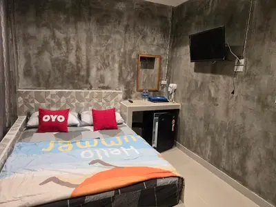 a bedroom with a bed with a tv on the wall at Gail's Hostels in Bangkok