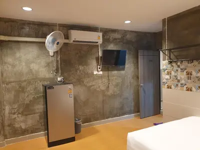 a room with a heater and a bed and a fan at Gail's Hostels in Bangkok