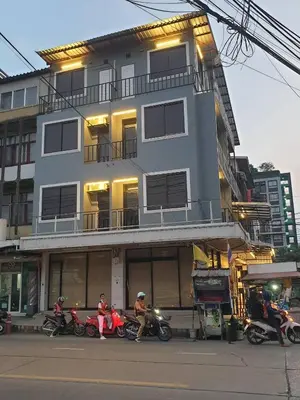 a group of motorcycles parked in front of a building at Gail's Hostels in Bangkok