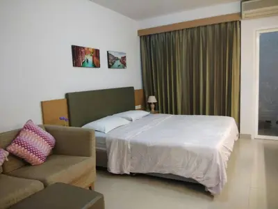 a hotel room with a bed and a couch at Savi Rooms Deluxe 3 Nr Bangkok piyavet Hospital in Bangkok