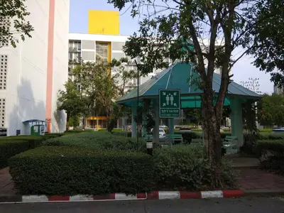 a small building with a sign in a park at Savi Rooms Deluxe 3 Nr Bangkok piyavet Hospital in Bangkok