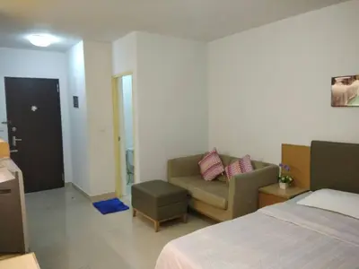 a bedroom with a bed and a couch and a chair at Savi Rooms Deluxe 3 Nr Bangkok piyavet Hospital in Bangkok