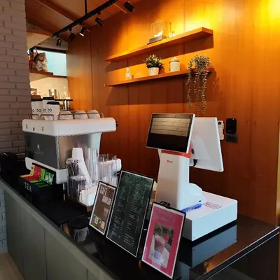 a coffee shop with a machine on a counter at ROOMS at Number60 Khaosan Bangkok in Bangkok