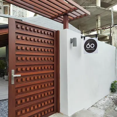 a wooden gate with a sign on it next to a building at ROOMS at Number60 Khaosan Bangkok in Bangkok