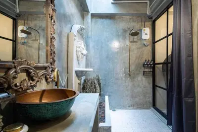 a bathroom with a large wooden tub in a room at Beautiful 3 Bedroom Baroque House near Asoke BTS in Bangkok