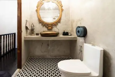 a bathroom with a toilet and a mirror at Beautiful 3 Bedroom Baroque House near Asoke BTS in Bangkok