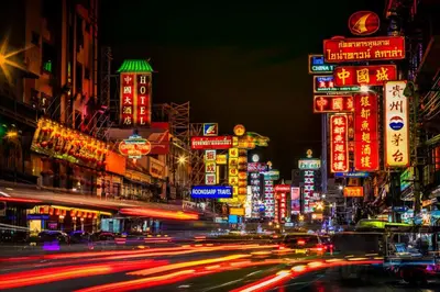 a busy city street at night with neon signs at XX Mitr Inn Yaowarat 2 - มิตร อินน์ เยาวราช in Bangkok