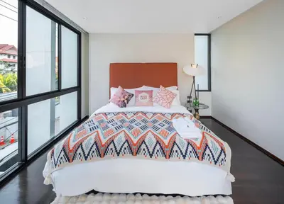a bedroom with a large bed and large windows at \u66fc\u8c37\u6cf0\u5883\u5962\u5922\u5225\u5885 in Ban Nong Rong (1)