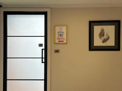 a door with a picture and a bird on the wall at The Residences at C&C in Bangkok