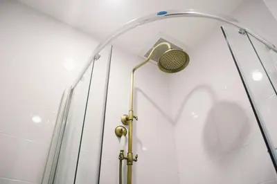 a shower with a shower head in a room at The Residences at C&C in Bangkok