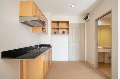 a kitchen with a sink and a refrigerator at 181 Ekkamai Studio Apartment in Bangkok