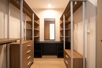 a walk in closet with a vanity and a mirror at 181 Ekkamai Studio Apartment in Bangkok