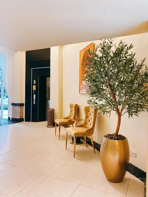 a large vase with a tree in a lobby at Kastel Bangkok Hotel in Bangkok