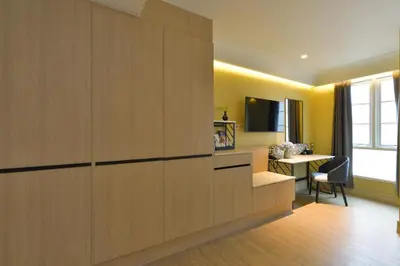 a hotel room with a large wooden wall at Kastel Bangkok Hotel in Bangkok