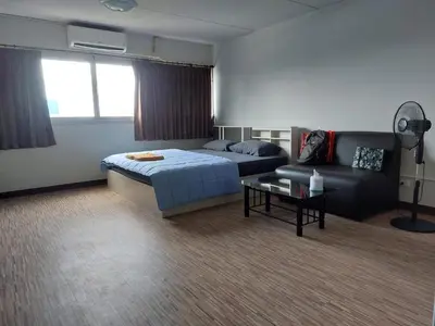 a bedroom with a bed and a couch at Solitude Skies14th Floor Studio in Nonthaburi